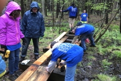 Puncheon Crew repairing a bridge on a trail behind the HNC