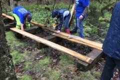 Puncheon Crew repairing a bridge on a trail behind the HNC